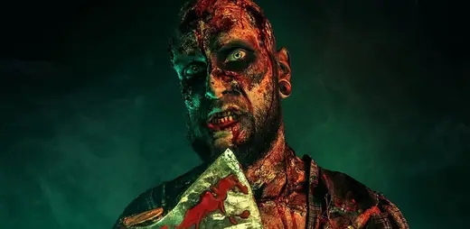 A masked figure lit red in the desert dark at Scarizona Scaregrounds in Mesa, Arizona